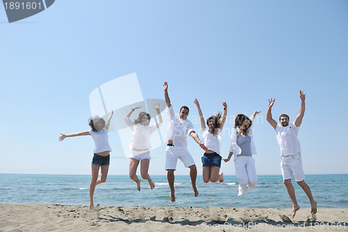 Image of happy people group have fun and running on beach