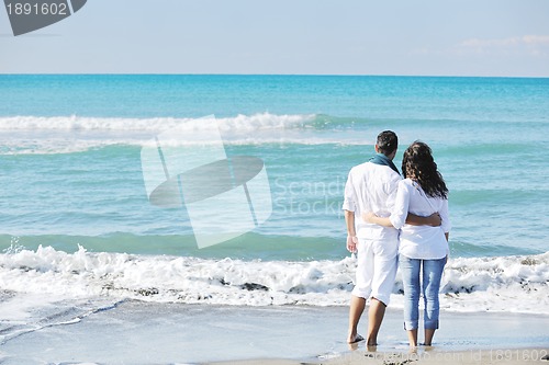 Image of happy young couple have fun at beautiful beach