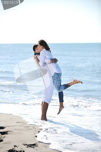 Image of happy young couple have fun at beautiful beach