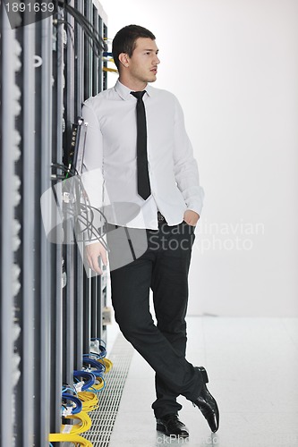 Image of young it engeneer in datacenter server room