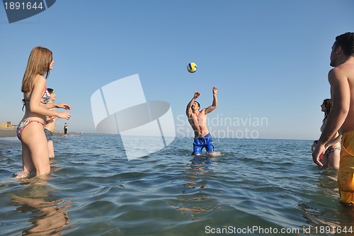 Image of young people group have fun and play beach volleyball