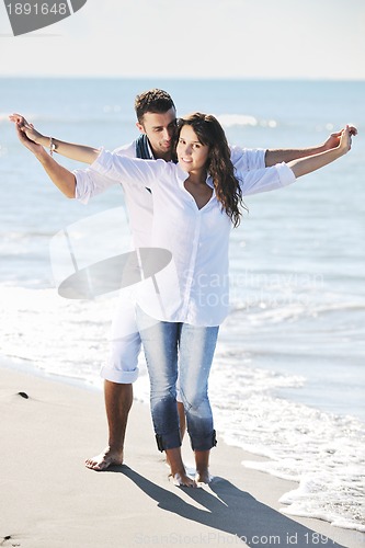 Image of happy young couple have fun at beautiful beach