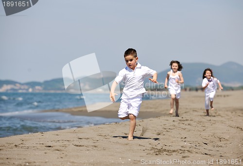 Image of happy child group playing  on beach