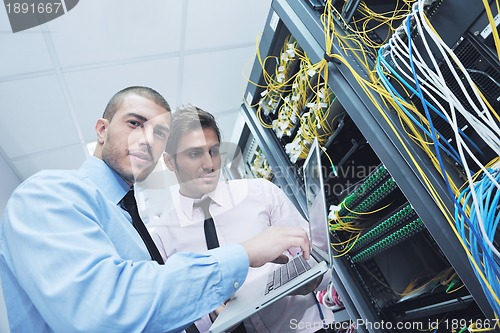 Image of it engineers in network server room