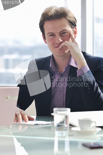 Image of  business man alone in conference room