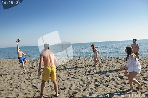 Image of young people group have fun and play beach volleyball