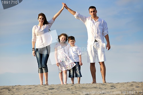 Image of family on beach showing home sign