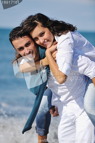 Image of happy young couple have fun at beautiful beach