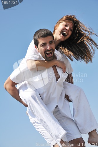 Image of happy young couple have fun on beach