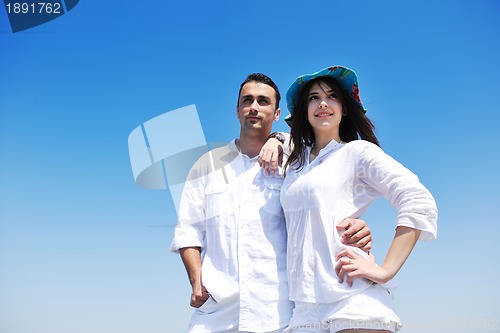 Image of happy young couple have fun on beach