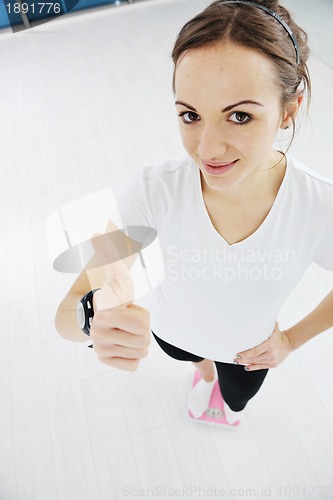 Image of happy diet concept with young woman on pink scale