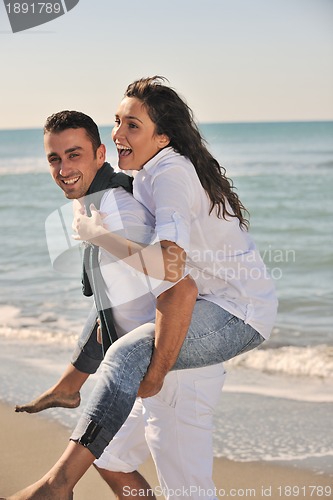 Image of happy young couple have fun at beautiful beach