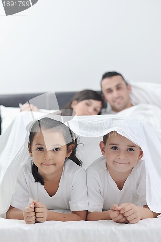 Image of happy young Family in their bedroom