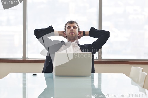 Image of young business man alone in conference room