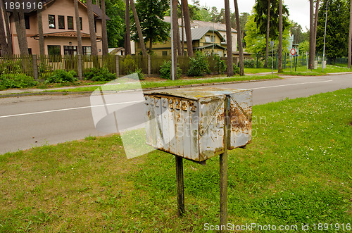 Image of Old rusty mailboxes retro wooden houses district 