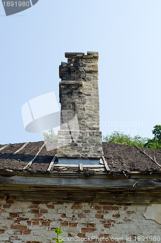 Image of Ancient collapsing building wall roof and chimney 