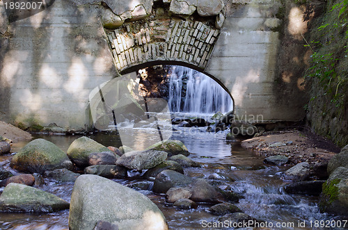 Image of Retro architecture arch in wall and stream flow 