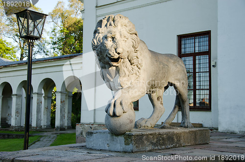 Image of Retro stone lion sunlight with sun in park 