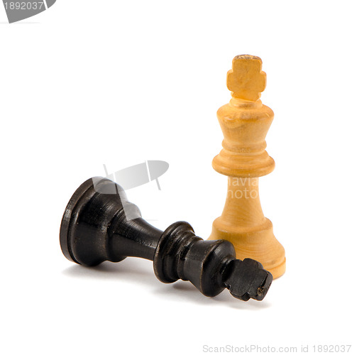 Image of Black chess king lie near winner white legs 