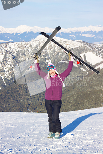 Image of Girl with skis in mountains