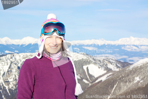 Image of Smiling girl in snowy mountains