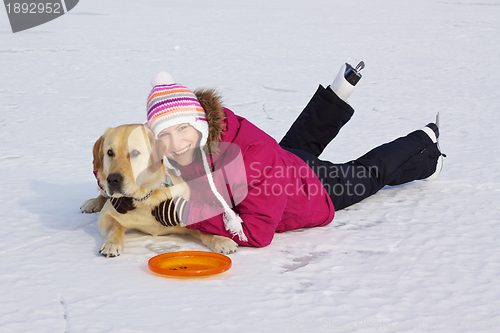 Image of Girl with her dog posing in snow