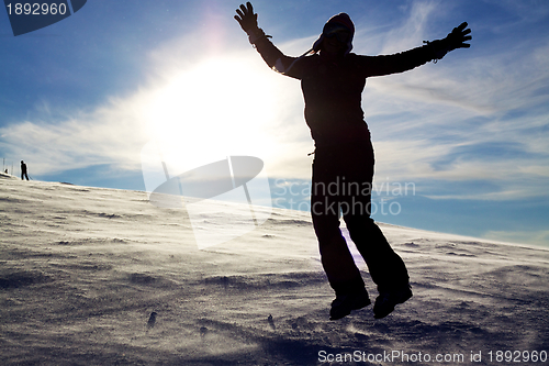 Image of Girl jumping in snow