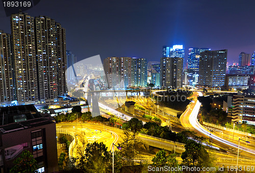 Image of traffic light through city at night