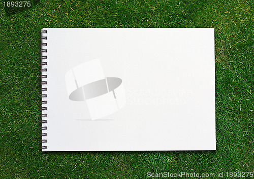 Image of  notebook on grassland