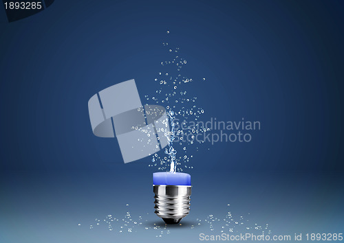 Image of Wax candle into lighting bulb with water splashes