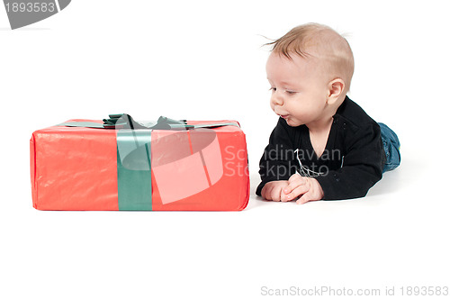 Image of Beautiful baby boy and big christmas present