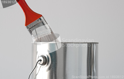 Image of Paint bucket and red paintbrush