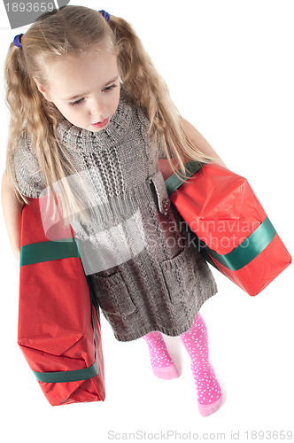 Image of Beautiful girl walking with christmas presents