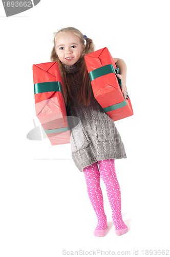 Image of Beautiful girl standing with christmas presents