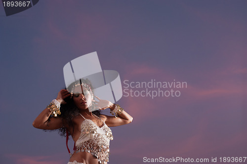 Image of Oriental dancer against evening sky