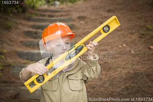 Image of Adorable Child Boy with Level Playing Handyman Outside