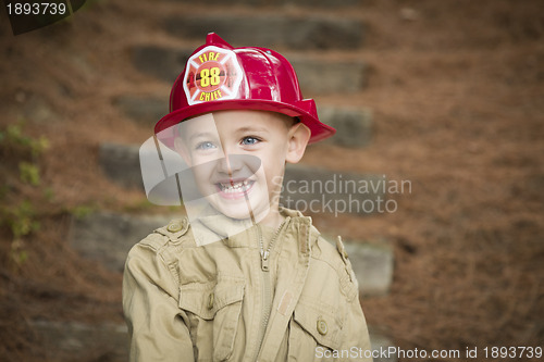 Image of Adorable Child Boy with Fireman Hat Playing Outside