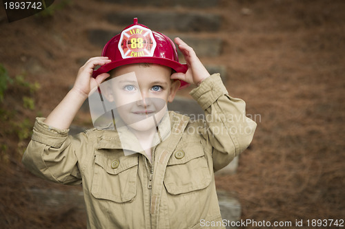 Image of Adorable Child Boy with Fireman Hat Playing Outside