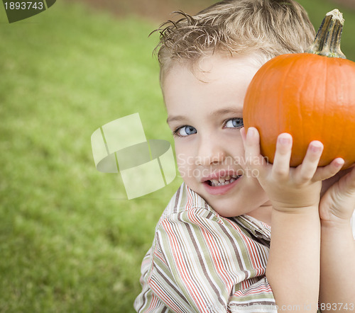 Image of Cute Young Child Boy Enjoying the Pumpkin Patch.