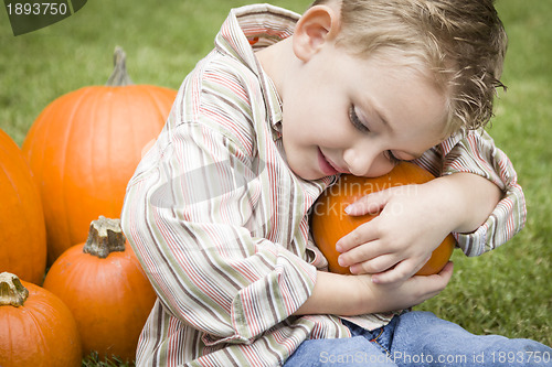 Image of Cute Young Child Boy Enjoying the Pumpkin Patch.