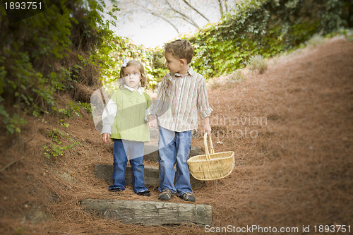 Image of Two Children Walking Down Wood Steps with Basket Outside.