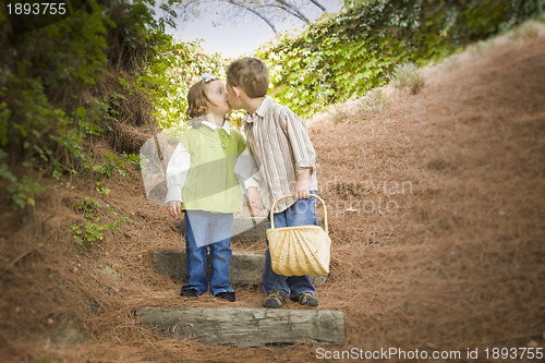 Image of Two Children with Basket Kissing Outside on Steps