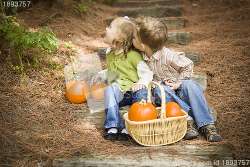 Image of Brother and Sister Children on Wood Steps with Pumpkins Playing