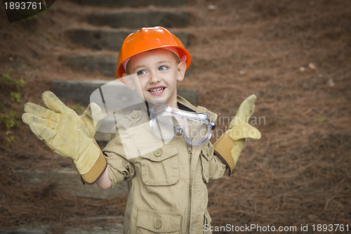 Image of Adorable Child Boy with Big Gloves Playing Handyman Outside