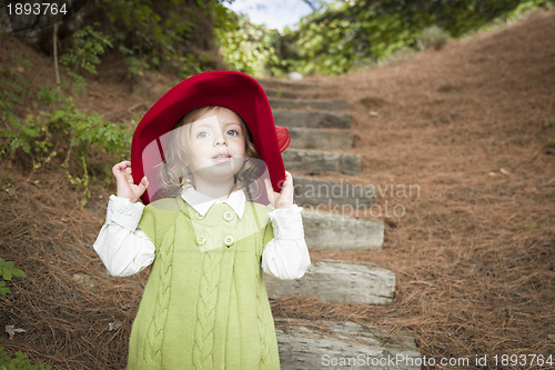 Image of Adorable Child Girl with Red Hat Playing Outside