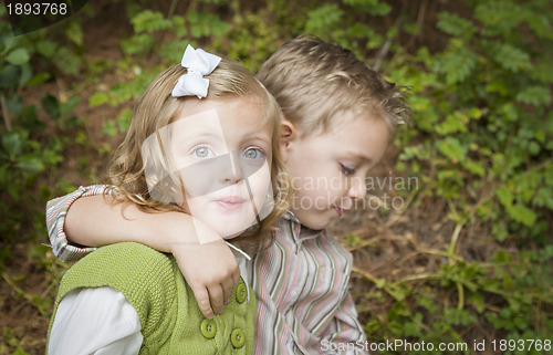 Image of Adorable Brother and Sister Children Hugging Outside