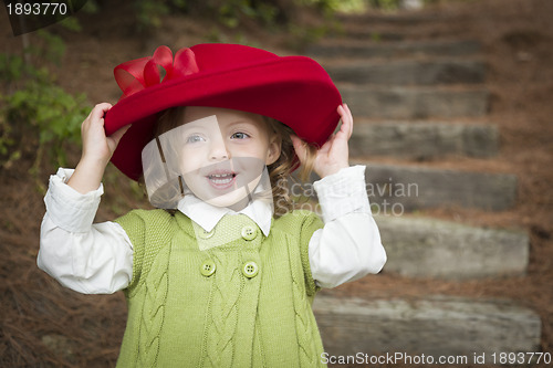 Image of Adorable Child Girl with Red Hat Playing Outside