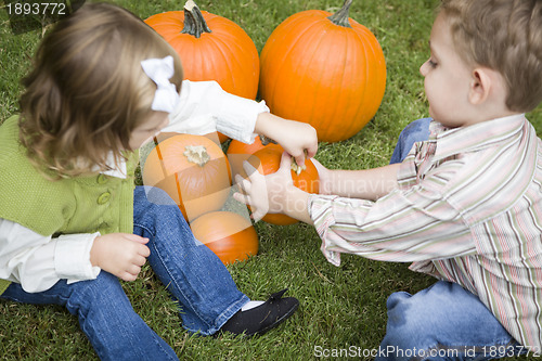 Image of Cute Young Brother and Sister At the Pumpkin Patch