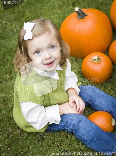 Image of Cute Young Child Girl Enjoying the Pumpkin Patch.