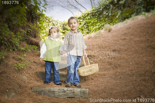 Image of Two Children Walking Down Wood Steps with Basket Outside.